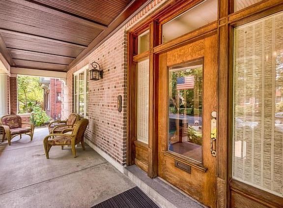 Impressive front door with side windows and transom windows above welcomes  you into the home