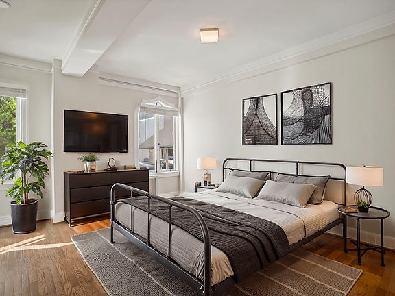 Bedroom with bed, pillows, blankets, and lamps