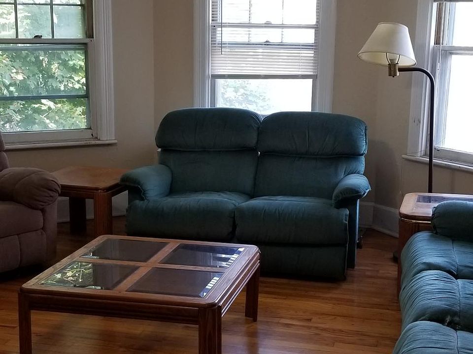 front living room with hardwood floors, ceiling fan and recliners