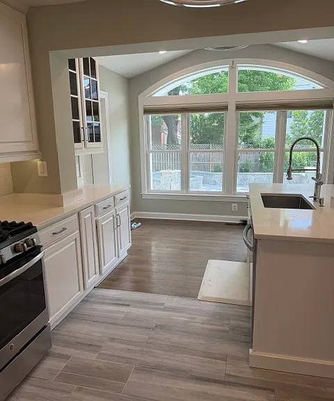 Renovated kitchen opens to the sitting room and overlooks the backyard