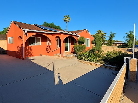 Expansive driveway with electric gate access and room for multiple vehicles.