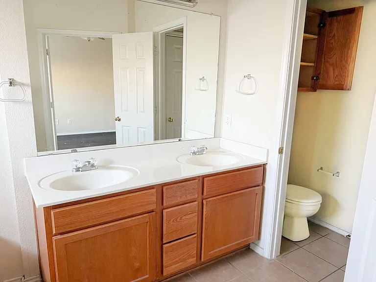 The master bathroom double sinks and toilet room.