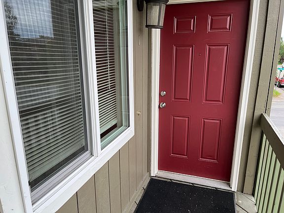 Door to the unit, large window on the left is the dining room