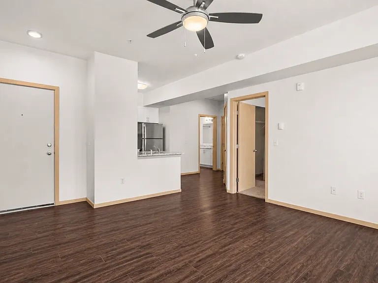 Spacious living area with wood-style flooring Spacious living area with wood-style flooring