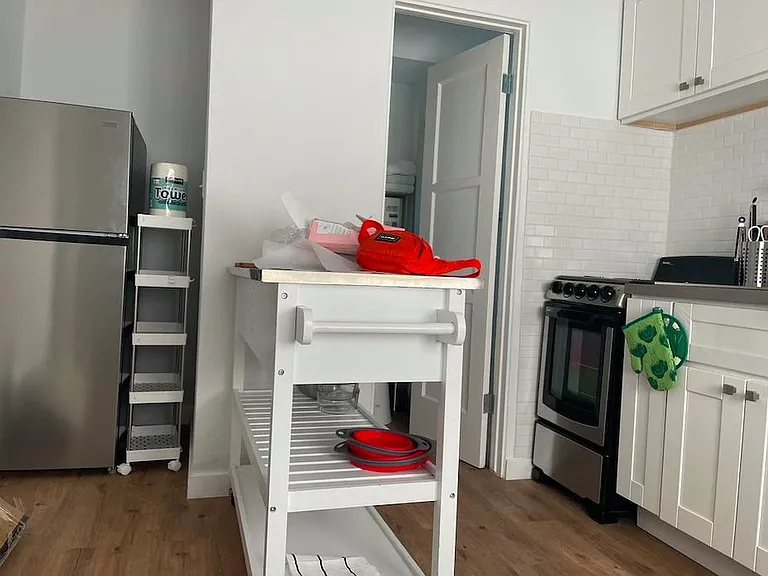 Refrigerator, separate door leading to bathroom