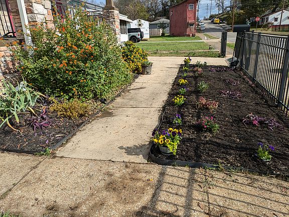 Front partial fence with new flower beds