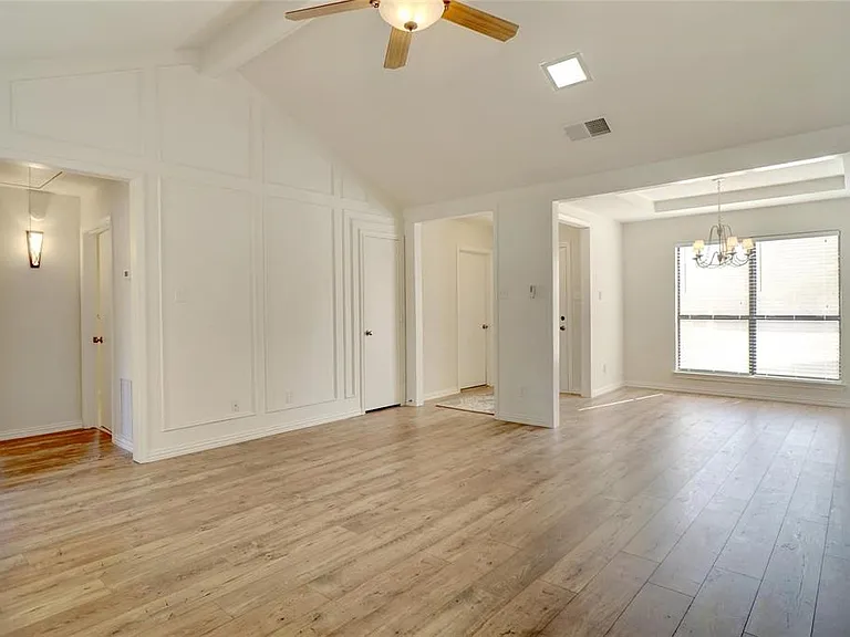View towards front door and dining room (or study/office). SPLIT FLOOR PLAN - hall to secondary bedrooms on left.