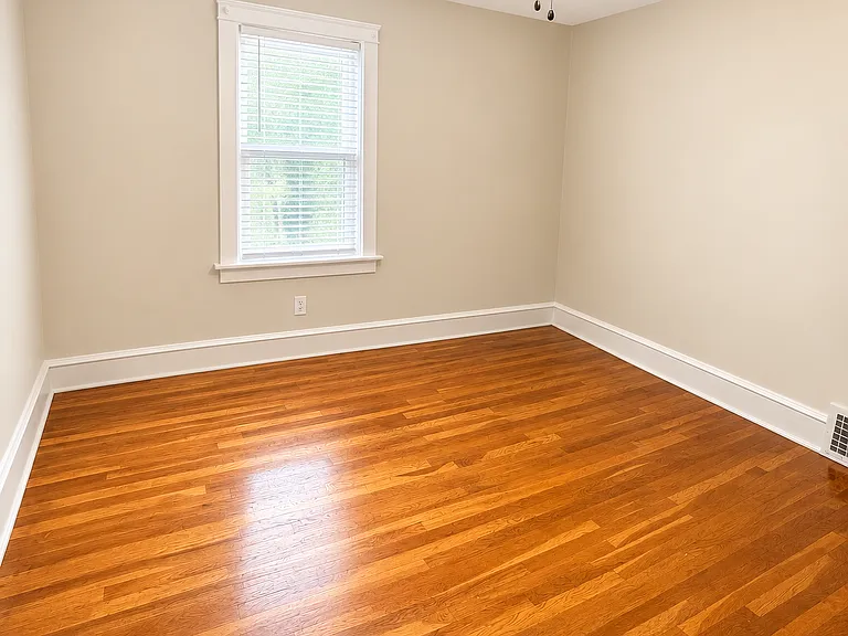 Second bedroom hardwood floors throughout neutral colors, closet space
