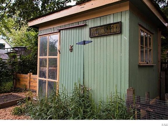 Potting shed built circa 1865 with original hardware and copper rooster weather vane on top of pagoda roof.