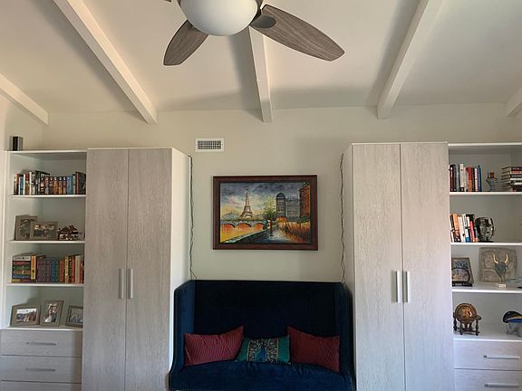 Custom cabinetry and shelving at entry in living room.