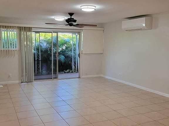 Living area next to kitchen - Split A/C and lanai with private yard
