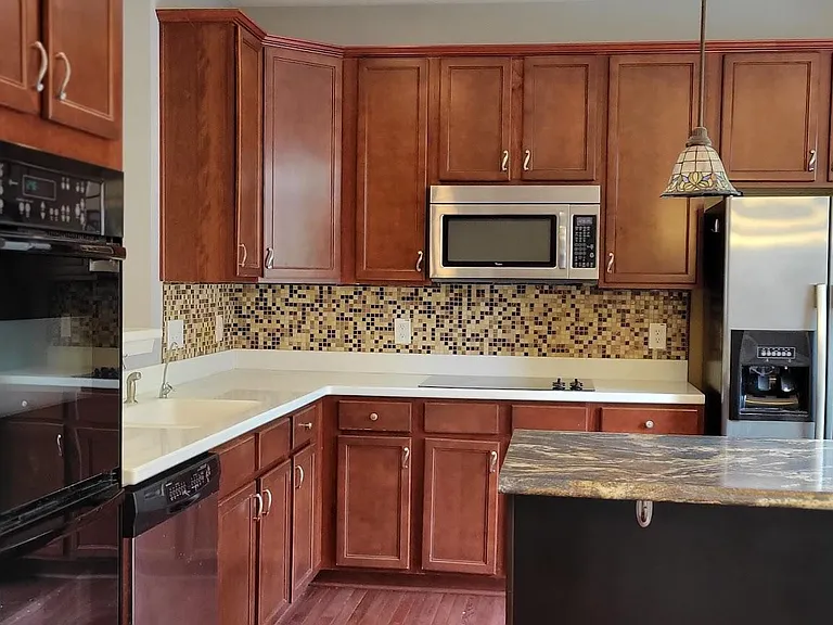 The kitchen's high-quality appliances make meal preparation a pleasurable experience.