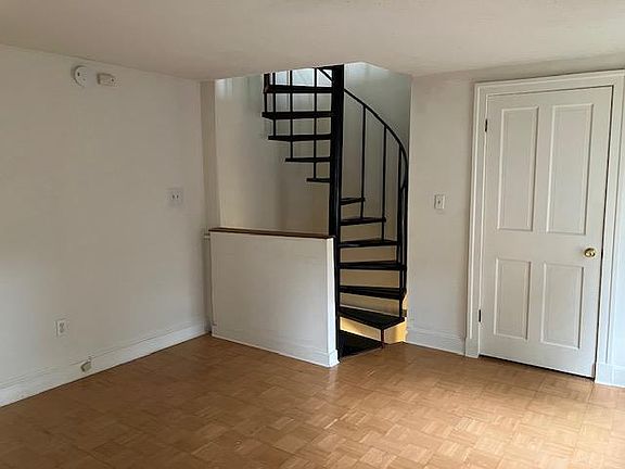 living room with stairs to third floor