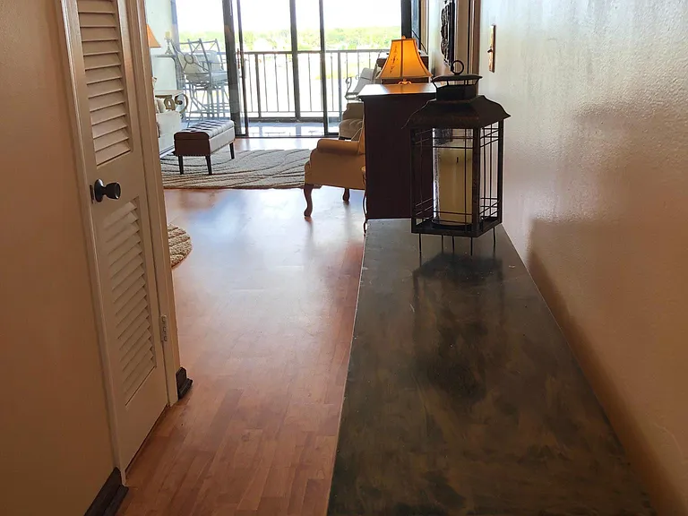Entry to unit. Kitchen and living room to the left. 2 bedrooms and their baths to the right