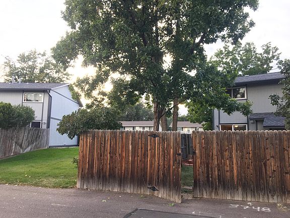 View from parking area of private fenced yard