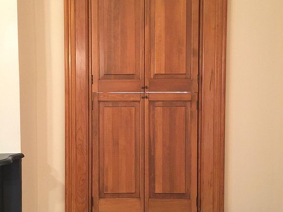 Historic wooden interior shutters throughout living room and