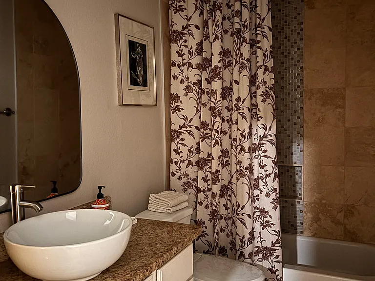 Guest bathroom with updated vanity and shower.