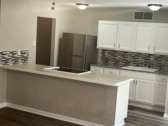 Brand new stainless steel refrigerator and like new modern matching stove.
