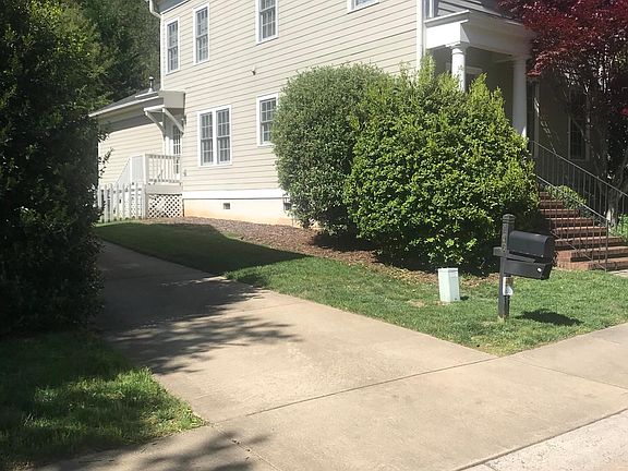 Side of house and side door to fenced backyard.