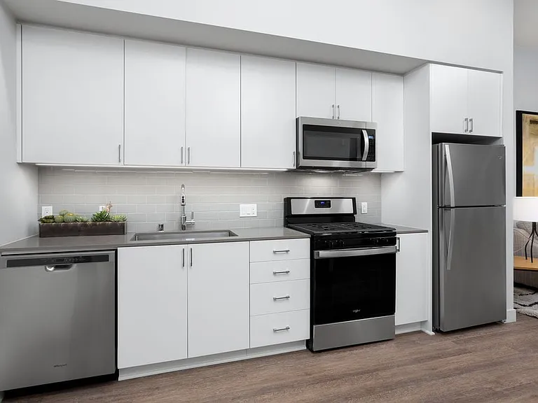 Building B Avalon Design kitchen with quartz countertops, backsplash and stainless steel appliances