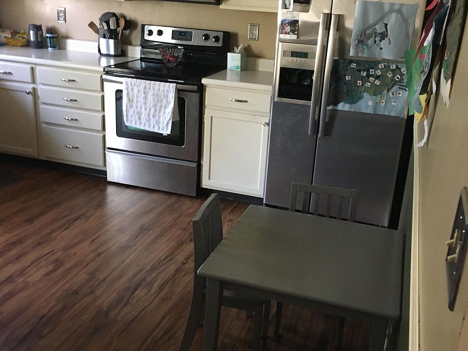 Spacious kitchen with stainless steel appliances; opens onto a deck.