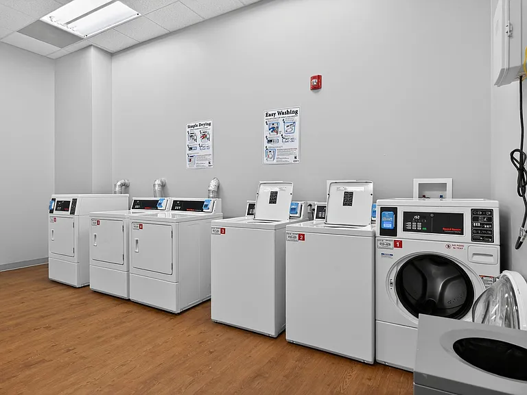 Modern laundry room with sleek washers and dryers, offering a clean and efficient space for washing clothes.