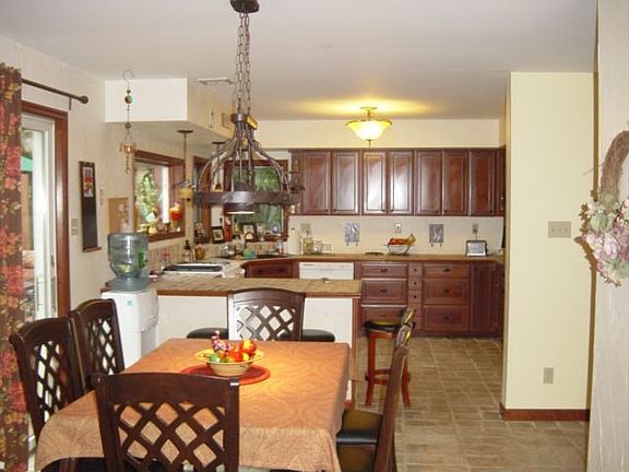 BIG kitchen w/tumbled stone floors, counters, copper farmer's sink 