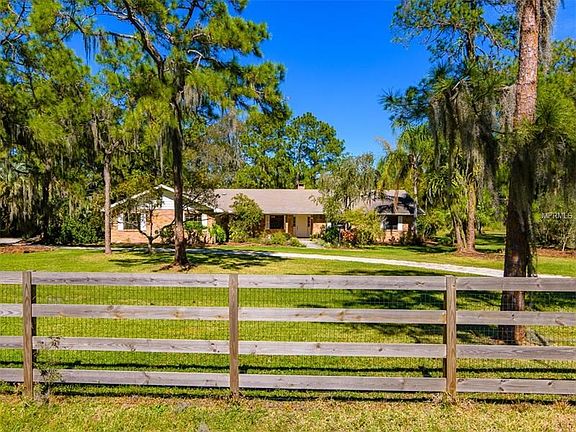 Entire perimeter of the 5+ acres is horse fenced with additional mesh backing, and a professionally 