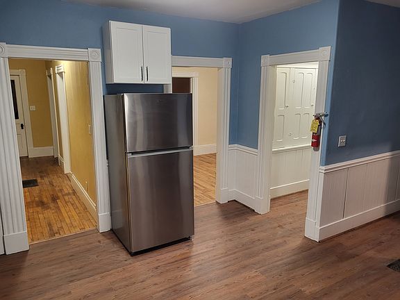 Kitchen, looking toward front hallway, dining room, pantry and side entrance hallway with downstairs half bath