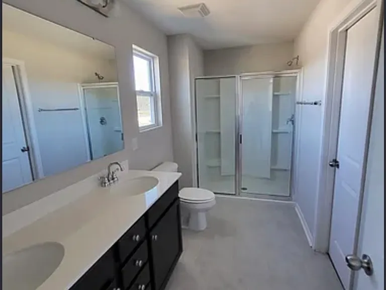 Primary bathroom with walk-in closet and linen closet