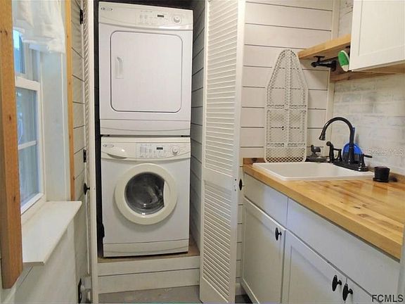 This is the laundry room. Perfect folding area, with a utility sink and space to hang dry clothes. Washer/dryer hidden behind doors.