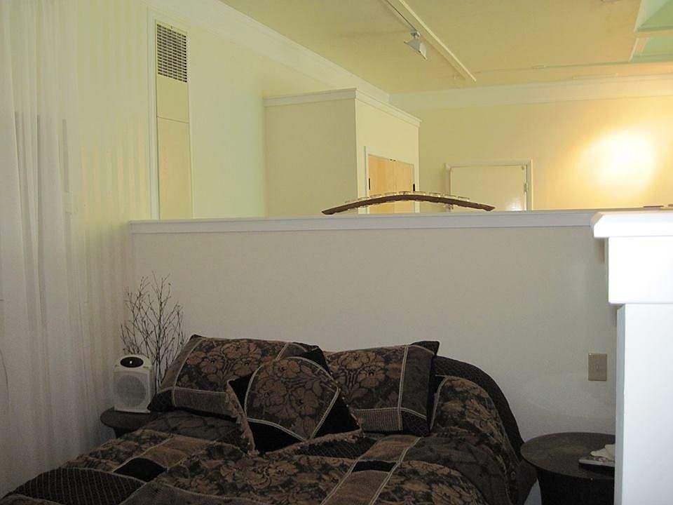 Bed included! Large wall built in shelfing in bedroom behind sheer curtains (left side of this pic). Additionally, both large closets have metal framed cabinets within them for more storage.