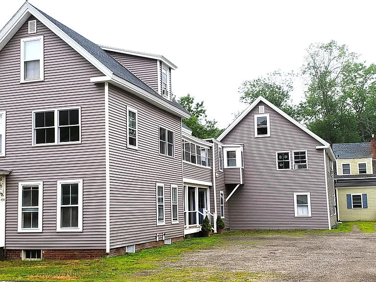 484 Main St has a gravel driveway and plenty of assigned parking spaces for tenants.