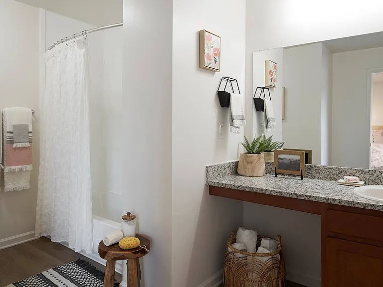 Start your day in a spacious bathroom featuring granite countertops and modern design at The Preserve at Tuscaloosa.