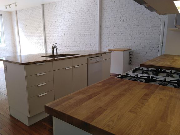 Kitchen includes dishwasher, gas stove, refrigerator, microwave, granite and woodblock counters as well as lots of cabinets and a pull out pantry. There is also a front loading washer and dryer in the apartment, not shown here.