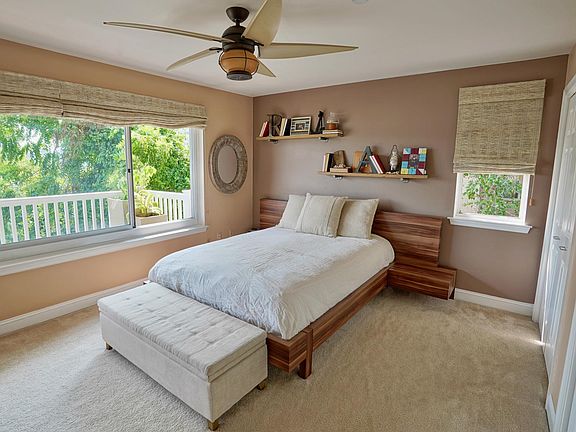 Bright and cheery master bedroom with twin closets