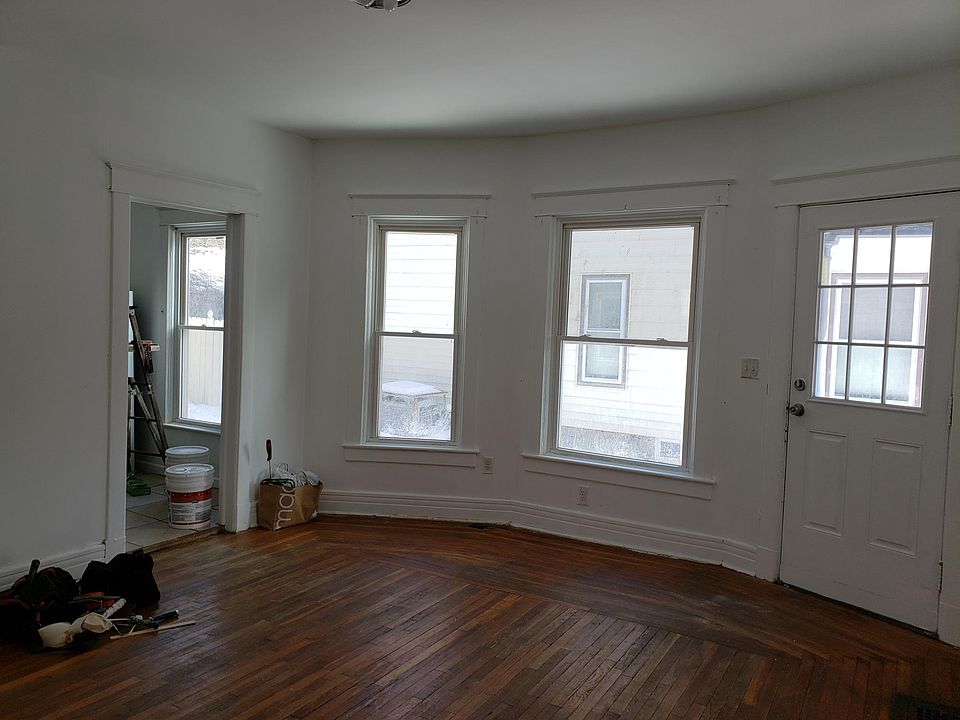 Large Living Room with oak hardwood floors, newly refinished in a beautiful natural tone. Repainting soon!