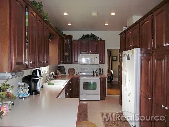 Gorgeous kitchen with Lafata Cherry Cabinets and lots of cupboard and counter space