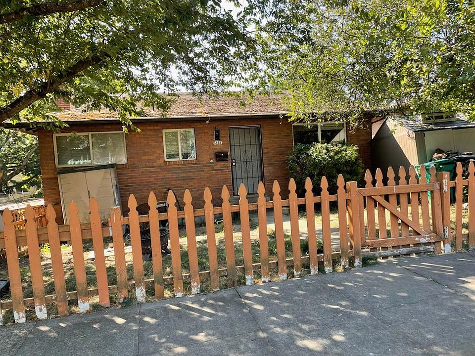 Front of the house with fence. Beautiful trees and shade
