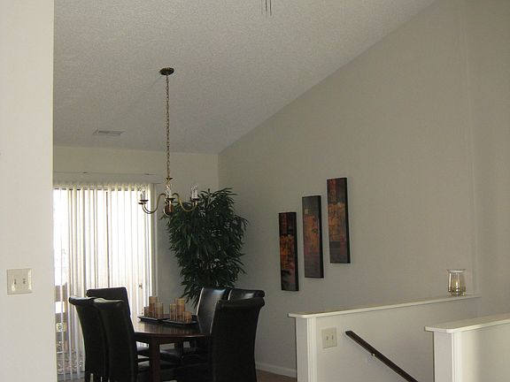 Entry and Dining Room, Cathedral Ceiling, Sliding Door to Deck - Furnished by Previous Tenant (previous carpet shown in all photos)