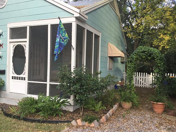 Side of cottage leading to gate opening into FENCED BACK YARD