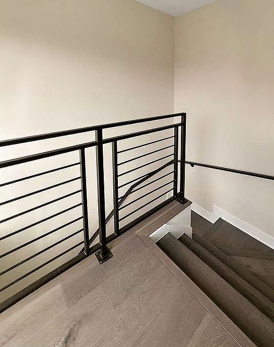 Stairs up to bedroom and sliding glass doors to deck