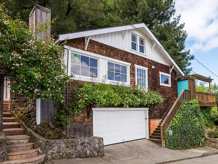 Street view featuring two entrances and garage.