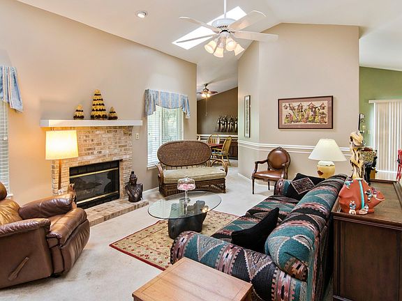 Main floor living room with vaulted ceiling and fireplace