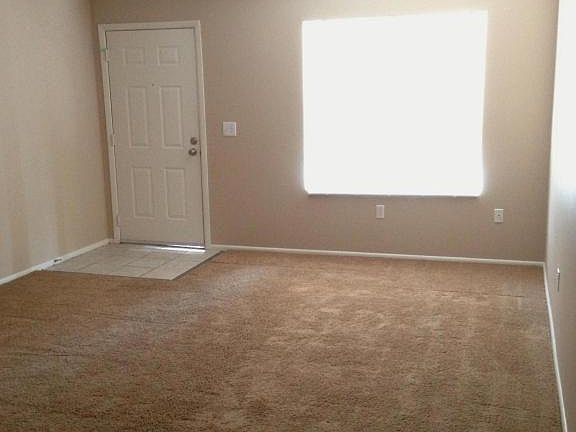 living room has a new paint, carpet, fan, lights and blinds