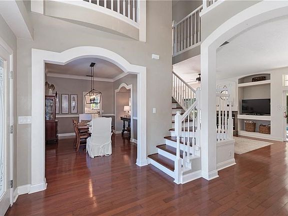Spacious entry foyer looking toward the dining room and with views to the back yard & pool.