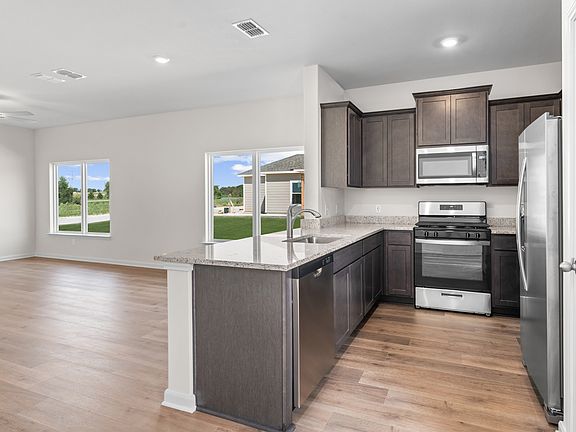 The kitchen has stainless steel appliances.