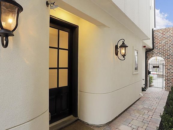 This Mediterranean style home has a sophisticated surveillance system starting with the front door camera.