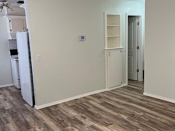Spacious living room with unique bookshelf nook & storage and laminate wood flooring throughout!