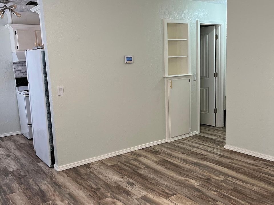 Spacious living room with unique bookshelf nook & storage and laminate wood flooring throughout!